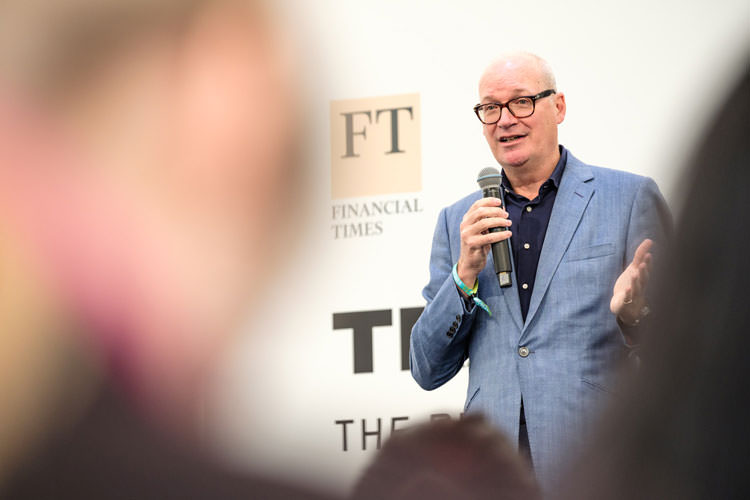 A man presenting at the financial times stand in Amsterdam's TNW event