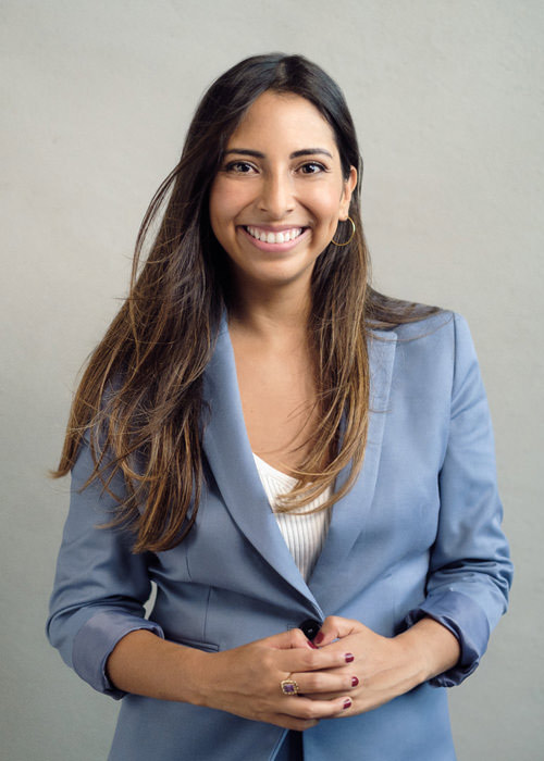 A LinkedIn portrait of a professional woman wearing a blue suit