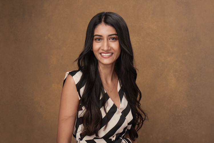 A studio portrait of a young professional Indian woman